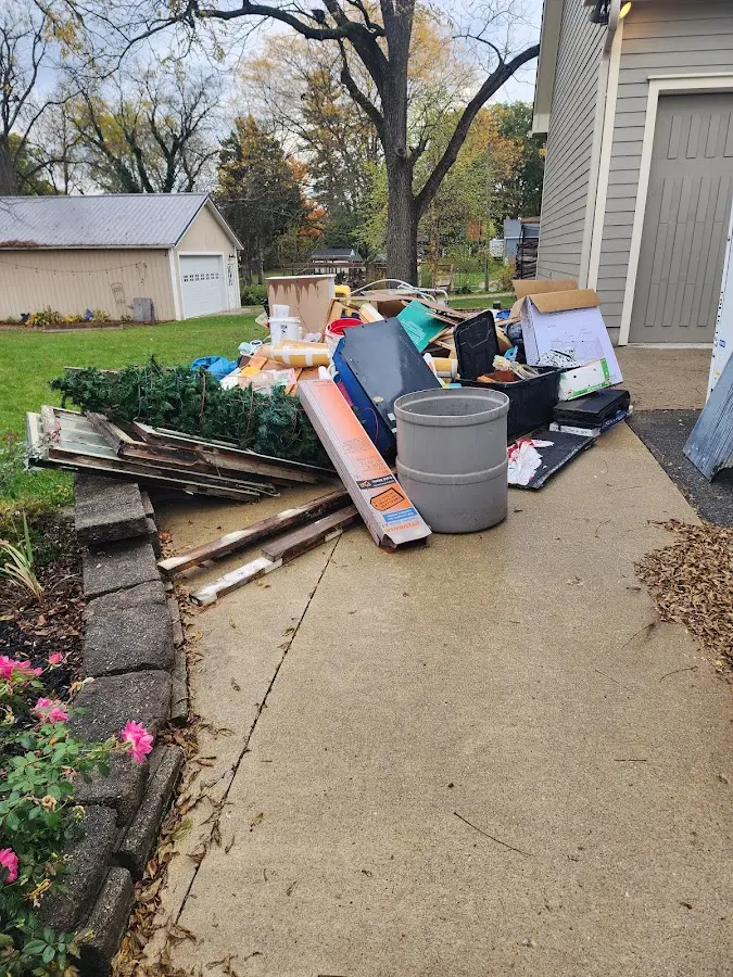 Dumpster being loaded with debris for Estate Cleanout Dumpster Rental in Caldwell